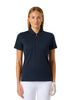 A woman modeling a short-sleeve polo shirt in dark navy blue with a half-zip collar, paired with white pants, against a light gray studio background.