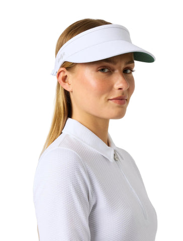A woman in a white polo shirt wearing a white visor with a green brim, photographed against a white studio background.