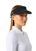 A woman in a white long-sleeve polo shirt wearing a black visor with a white logo, photographed against a light grey studio background.