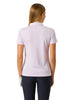 A woman viewed from the back wearing a pink short-sleeve polo shirt and dark navy leggings against a white studio background.