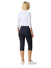 Woman wearing navy capri pants and a white top on a white background