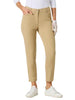 A woman modeling a white long-sleeve polo shirt and beige cropped trousers, standing against a light gray studio background.