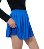 Person wearing a black top and blue pleated skirt on a plain background