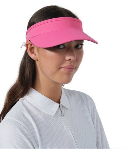Woman wearing a pink visor against a white background