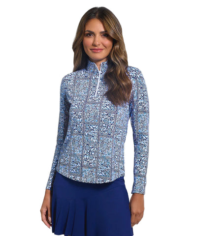 Woman wearing a blue patterned long-sleeve top and blue skirt on a white background