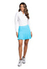 Woman wearing a white long-sleeve top and turquoise skirt on a white background