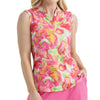 Woman wearing a sleeveless, multicolored patterned top with pink pants on a light gray background