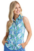 Woman wearing a sleeveless blue and green patterned shirt against a white background