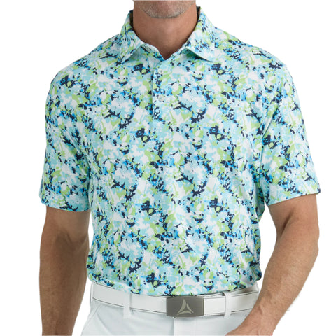 Man wearing a patterned polo shirt with a neutral background
