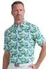 Man wearing a tropical leaf patterned shirt on a plain background