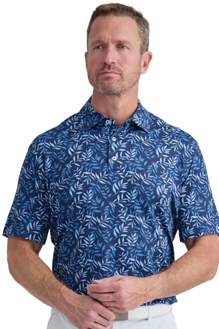 Man wearing a blue patterned shirt against a light gray background