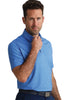 Man wearing a blue patterned polo shirt against a white background