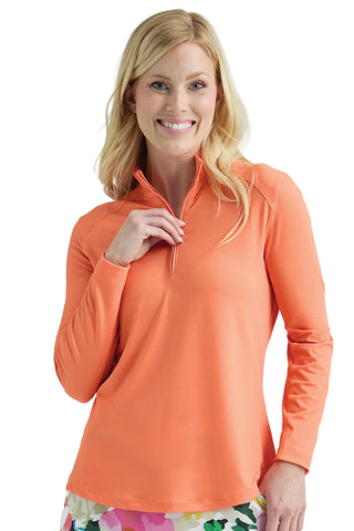 Woman wearing an orange long-sleeve shirt with a white background