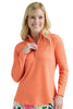 Woman wearing an orange long-sleeve shirt with a white background
