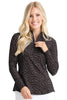 Woman wearing a black patterned long-sleeve shirt on a white background