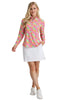 Woman wearing a colorful floral blouse and white skirt on a white background