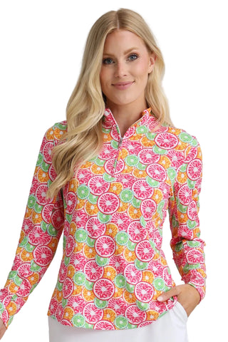 Woman wearing a colorful patterned shirt with a plain background