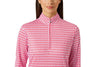 A woman wearing a red and white gingham long-sleeve polo shirt with a mock neck and a short front zipper, shown against a light gray studio background.