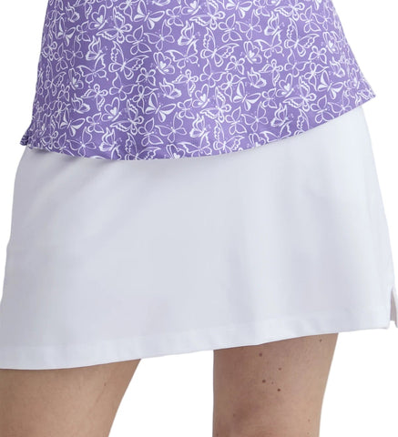 Purple patterned top and white skirt on a plain background