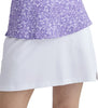 Purple patterned top and white skirt on a plain background