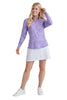Woman wearing a purple long-sleeve top and white skirt on a white background