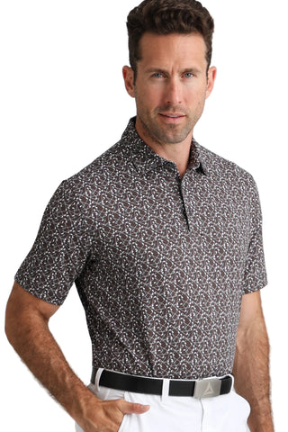 Man wearing a patterned short-sleeve shirt and white pants on a white background