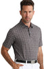 Man wearing a patterned short-sleeve shirt and white pants on a white background