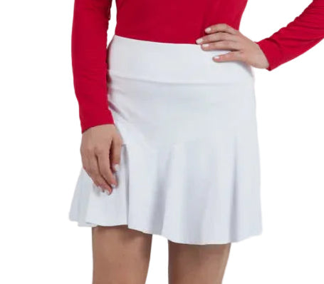 Woman wearing a red sweater and white skirt on a plain background