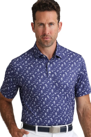 Man wearing a blue patterned polo shirt against a white background
