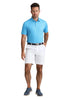 Man wearing a blue polo shirt and white shorts on a white background