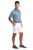 Man wearing a blue checkered shirt, white shorts, and navy shoes on awhite background
