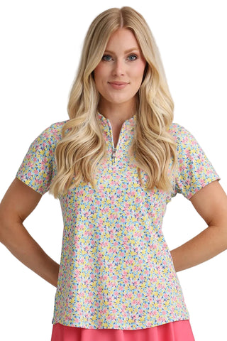 Woman wearing a colorful floral blouse with a plain background