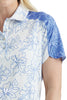Close-up of a person wearing a blue and white floral patterned shirt.