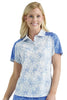 Woman wearing a white floral patterned polo shirt with blue accents on a plain background