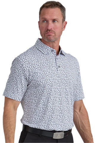 Man wearing a patterned short-sleeve shirt against a plain background