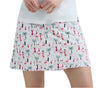Skirt with flamingo and palm tree pattern worn by a person on a white background