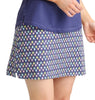 Person wearing a purple top and patterned skirt on a white background