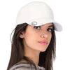 Woman wearing a white cap with a logo on a plain background
