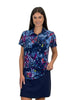 Woman wearing a colorful floral shirt and navy skirt on a white background