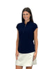 Woman wearing a navy sleeveless top and white skirt on a white background