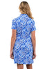 Woman wearing a blue floral dress against a white background