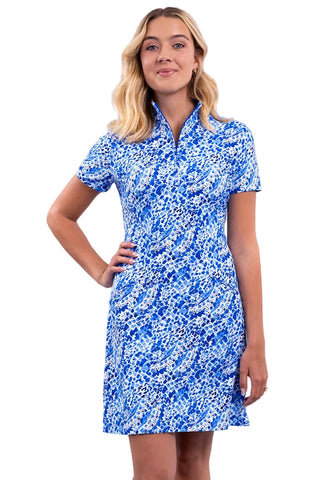 A woman modeling a short-sleeve collared dress with a blue and white abstract floral pattern, standing against a solid studio background.