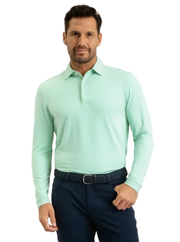 A man wearing a mint green long-sleeve polo shirt 