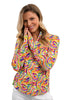 Woman wearing a colorful patterned shirt against a white background