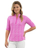 Woman wearing a pink patterned shirt and white pants on a white background