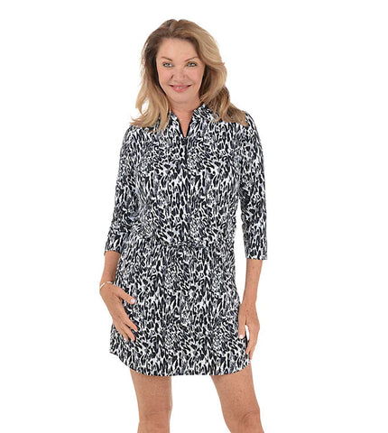 Woman wearing a black and white patterned dress on a white background