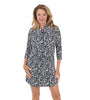 Woman wearing a black and white patterned dress on a white background