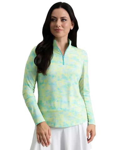 Woman wearing a colorful long-sleeve top and white skirt on a white background