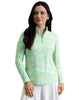 Woman wearing a colorful long-sleeve top and white skirt on a white background