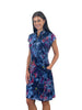Woman wearing a colorful floral dress on a white background